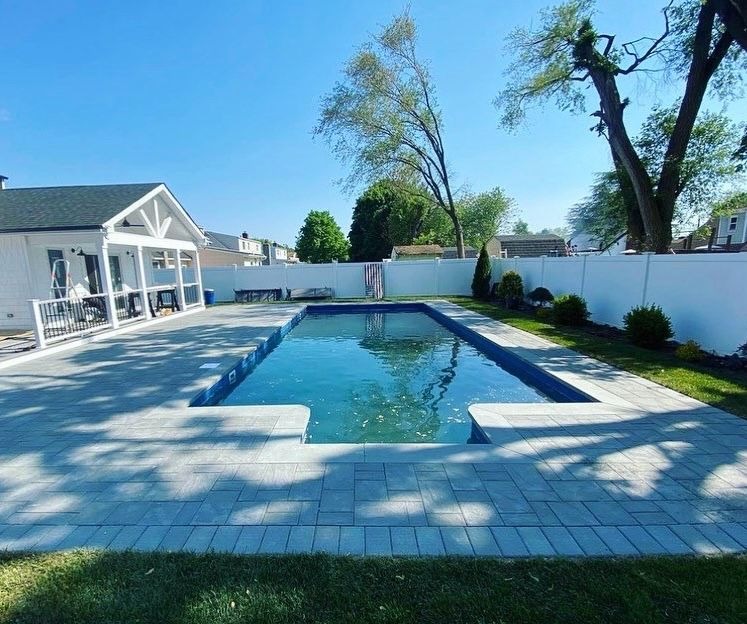 Custom pool patio and paver installation completed by Constructive Greens on Long Island.