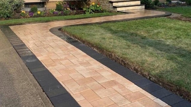 Custom paver walkway seamlessly integrated with a front home entrance, installed by Constructive Greens